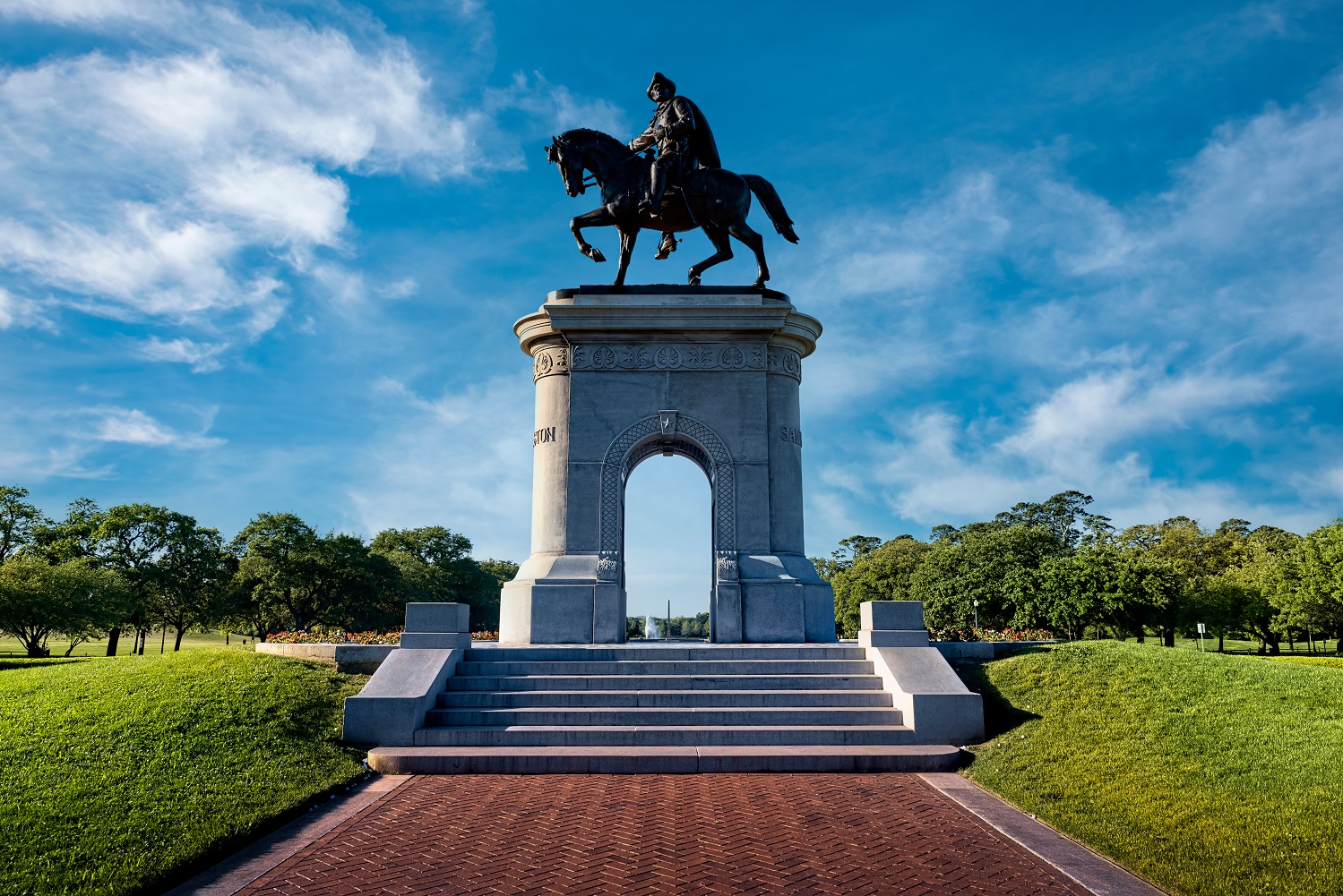 A statue of a person riding a horse on a pedestal.